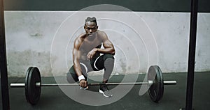 Weightlifting, fitness and portrait of black man with barbell in gym for training, exercise and workout. Strong body