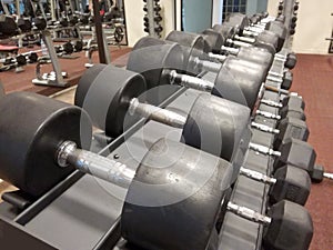 Weights.Rows of dumbbells on a rack.
