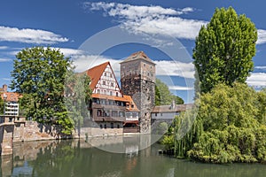 Weinstadle timbered building and Henkersteg or Hangmans Bridge reflected in Pegnitz River. Nuremberg, Bavaria, Germany