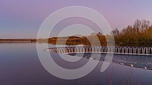 Weir of lake during sunset