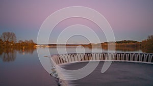 Weir of lake during sunset