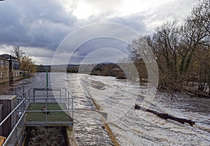 The weir at the River Wharfe in Otley with the river in spate after heavy rain throughout Yorkshire