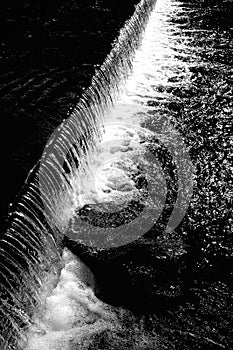 Weir on the River Wye, Bakewell, Derbyshire Peak district, England. Black and white. photo