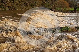 The weir at Tipton St John on the River Otter at fiull force with all the rain dropped by Storm Gareth