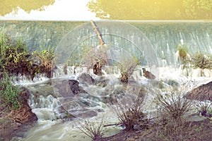 Weir to irrigate, small dam on the river. photo