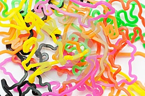 Weird creative shaped colorful rubber bands against a white backdrop