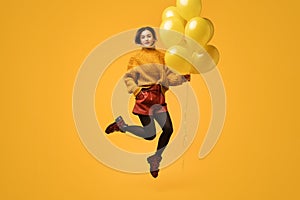 Weird female with balloons jumping and saluting