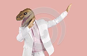 Weird guy wearing suit and funny dinosaur mask dancing and having fun at crazy party