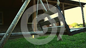 Weirdness. Old swing in the yard with light effect.