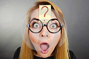 Weirdo nerd woman having question mark on forehead