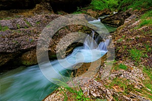 Weissbachschlucht a gorge with a blue mountain stream and many waterfalls forest a hiking trail plants and rocks