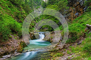 Weissbachschlucht a gorge with a blue mountain stream and many waterfalls forest a hiking trail plants and rocks