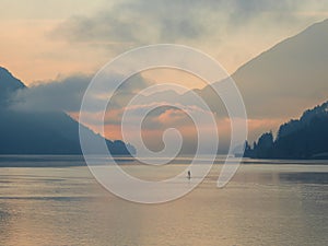 Weissensee - A stand up paddling man towards the sunset