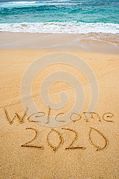 Welcome 2020 written in the sand