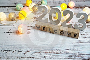 Welcome 2023 word alphabet letters on wooden background