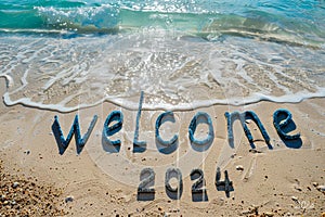 Welcome 2024 text written on the sand of the beach.