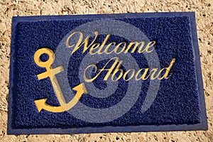 Welcome aboard blue mat. Beach cafe, yacht club Wellcome concept photo