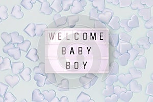 Welcome baby boy. Lightbox with letters and blue confetti in a heart shape.