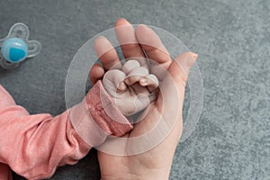 Welcome baby,Mother holding her newborn baby by little hand