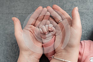 Welcome baby,Mother holding her newborn baby by little hand