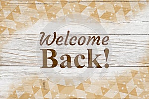 Welcome Back message with gold triangles swirl