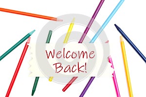 Welcome back message on wood sign with colored watercolor pencils