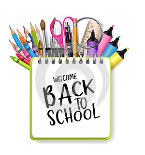 Welcome back to school background with a ring notebook and typography text. A pile of pencils, pens, scissors, markets, highlighte