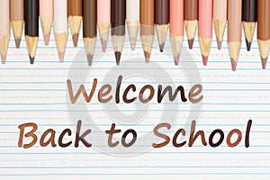Welcome Back to School message with multiculture skin tone color pencils