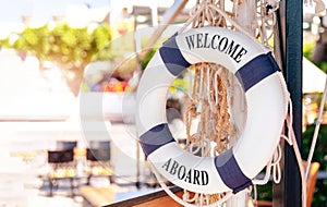 Welcome on Board - Lifebuoy with blue text on white background. Trip, travel concept. Space for text