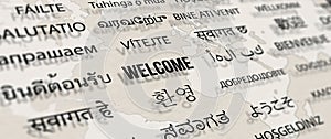 Welcome in different language on paper with world map background