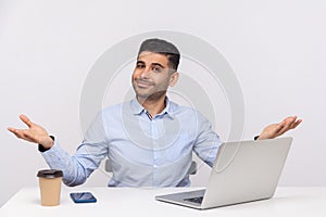 Welcome and give me hug! Friendly happy businessman sitting office workplace with laptop on desk, hands open