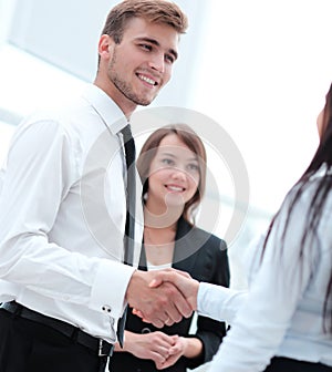 Welcome and handshake of business partners in the office.