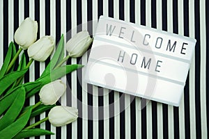 Welcome Home Light box letters Flat Lay with tulip flower bouquet