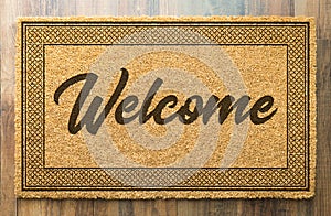 Welcome Mat On A Wood Floor Background