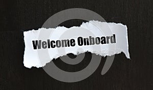 WELCOME ONBOARD words on a small white piece of paper and black background