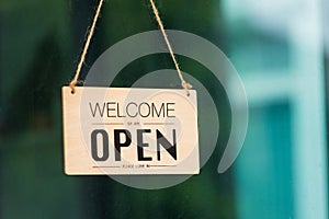 WELCOME WE ARE OPEN PLEASE COME IN notice sign wood board label hanging through glass door