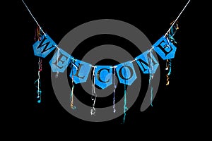 Welcome party banner. Blue bunting letters spelling the word welcome