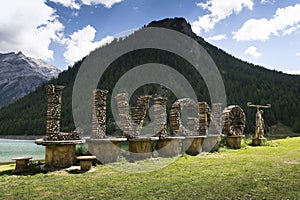 Welcome sign with bicycle straw sculpture in Livigno, Italy