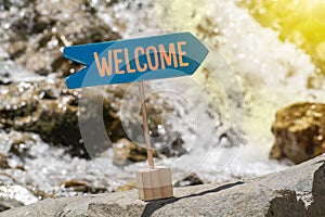 Welcome sign board on rock