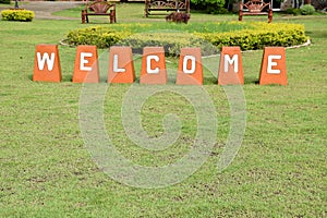 Welcome sign on green grass