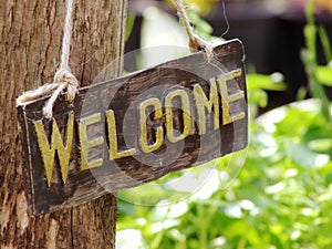 Welcome sign hanging in the garden