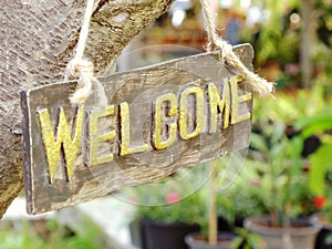 Welcome sign hanging in the garden