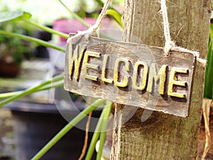 Welcome sign hanging in the garden