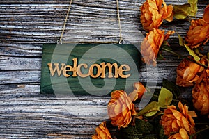 Welcome sign hanging on wooden with flower bouquet decoration