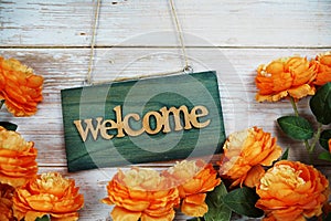 Welcome sign hanging on wooden with flower bouquet decoration