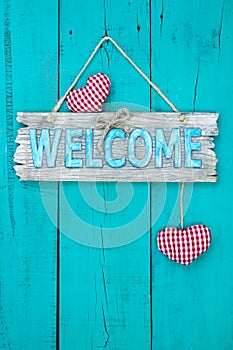 Welcome sign with hearts hanging on wood door