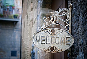 Welcome sign on log home