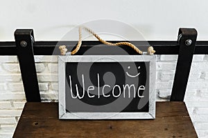 Welcome sign made by galvanized iron on wood table