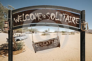 Welcome sign and rusty old vehicle in Solitaire. Solitaire is a small settlement in the Khomas Region of Central Namibia, Africa photo