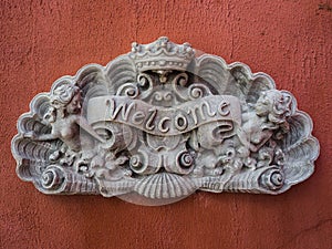 Welcome sign stone on wall